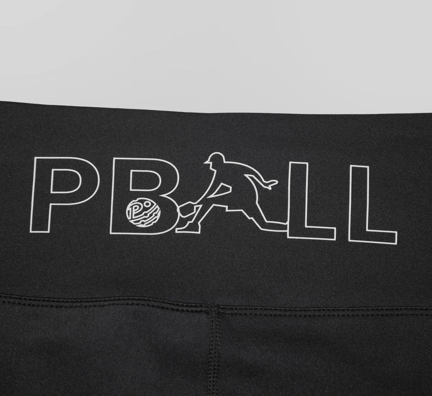 Black biker shorts with a white PBALL logo on a gray background