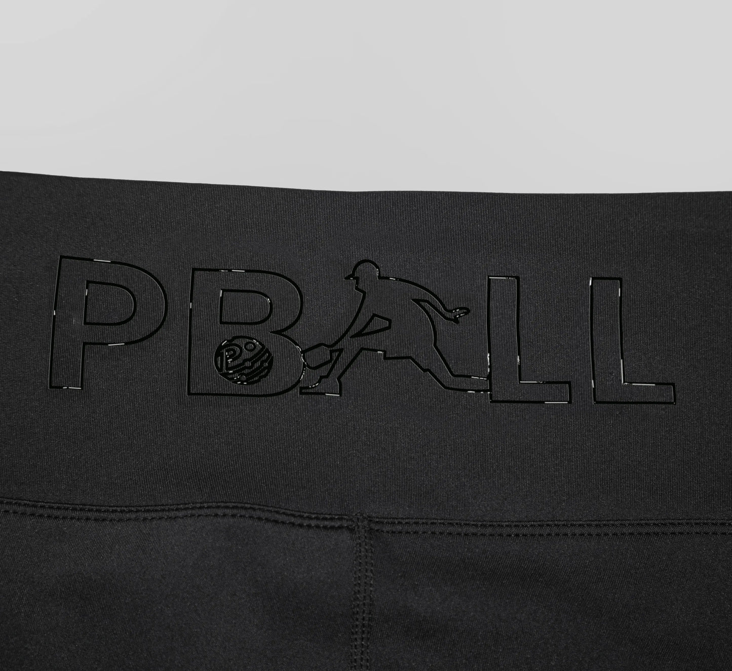 Black biker shorts with embossed PBALL logo on a gray background