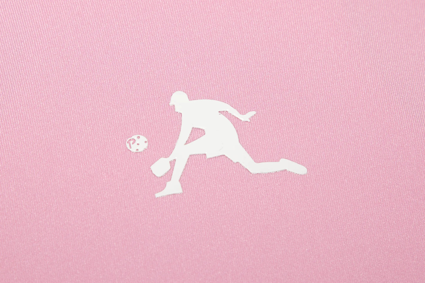 White silhouette of a person playing pickleball on a pink background