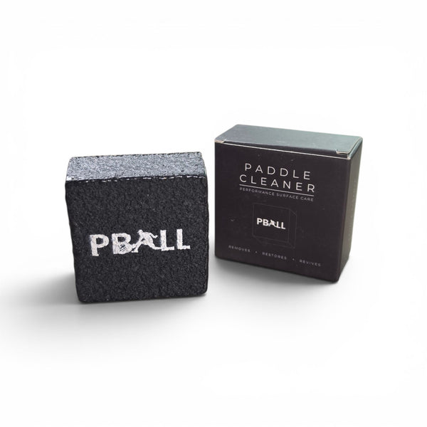 PBALL Paddle Cleaner kit showing a textured black cleaning stone with a white PBALL logo next to its black packaging box.