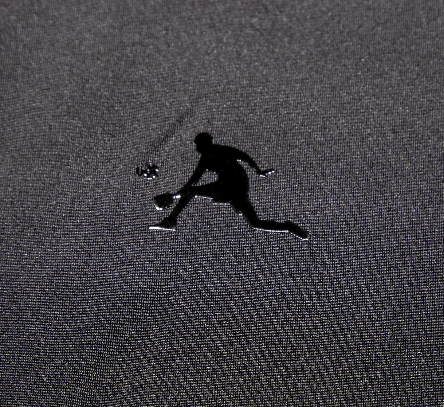 Black logo of a pickleball player on a textured gray surface Noir
