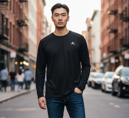 Man wearing a black long-sleeve shirt with a logo on a city street