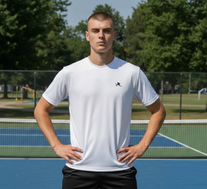 Person wearing a white t-shirt with a logo on a pickleball court