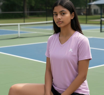 Person wearing a purple shirt on a pickleball court