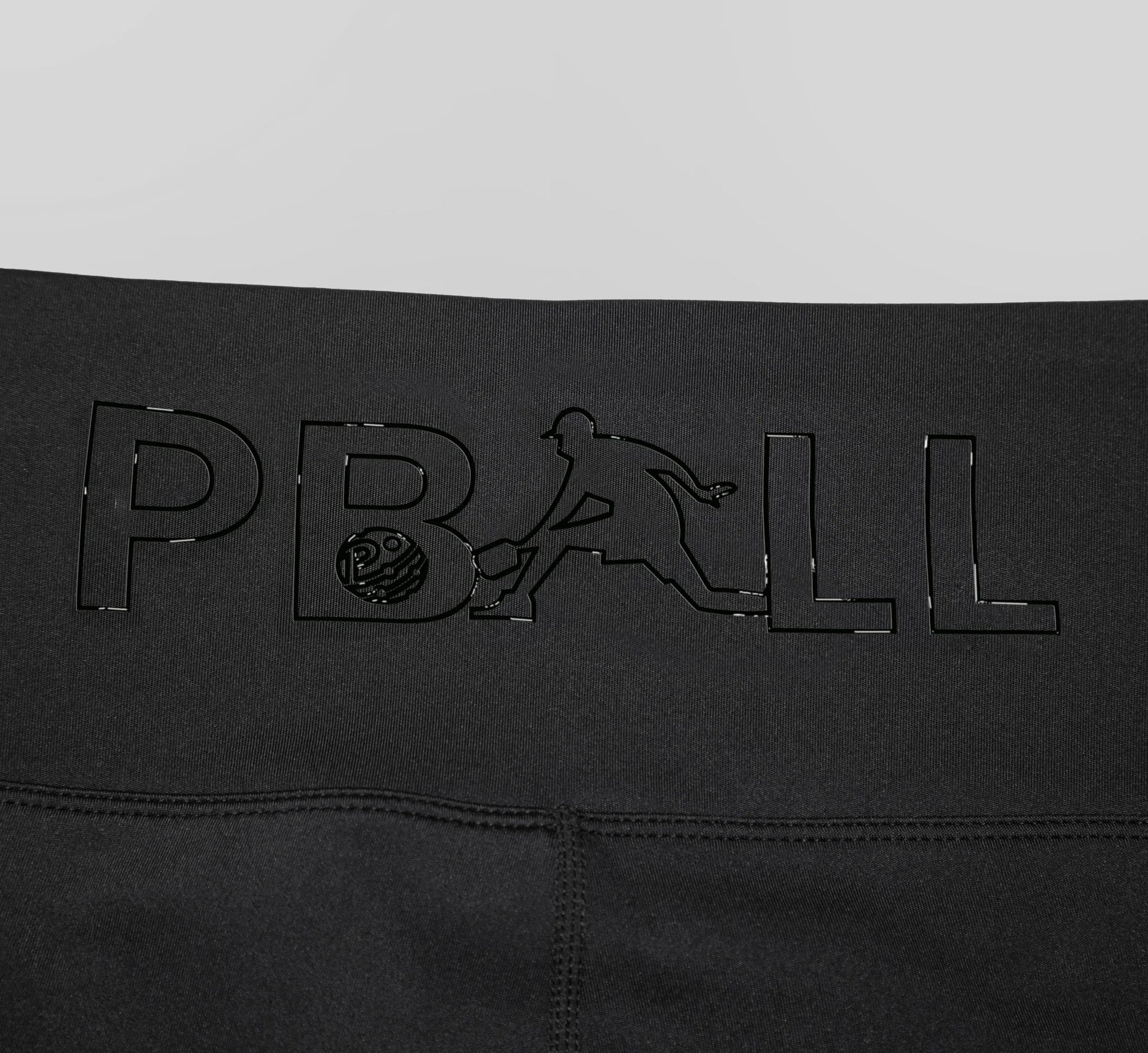 Black biker shorts with embossed PBALL logo on a gray background