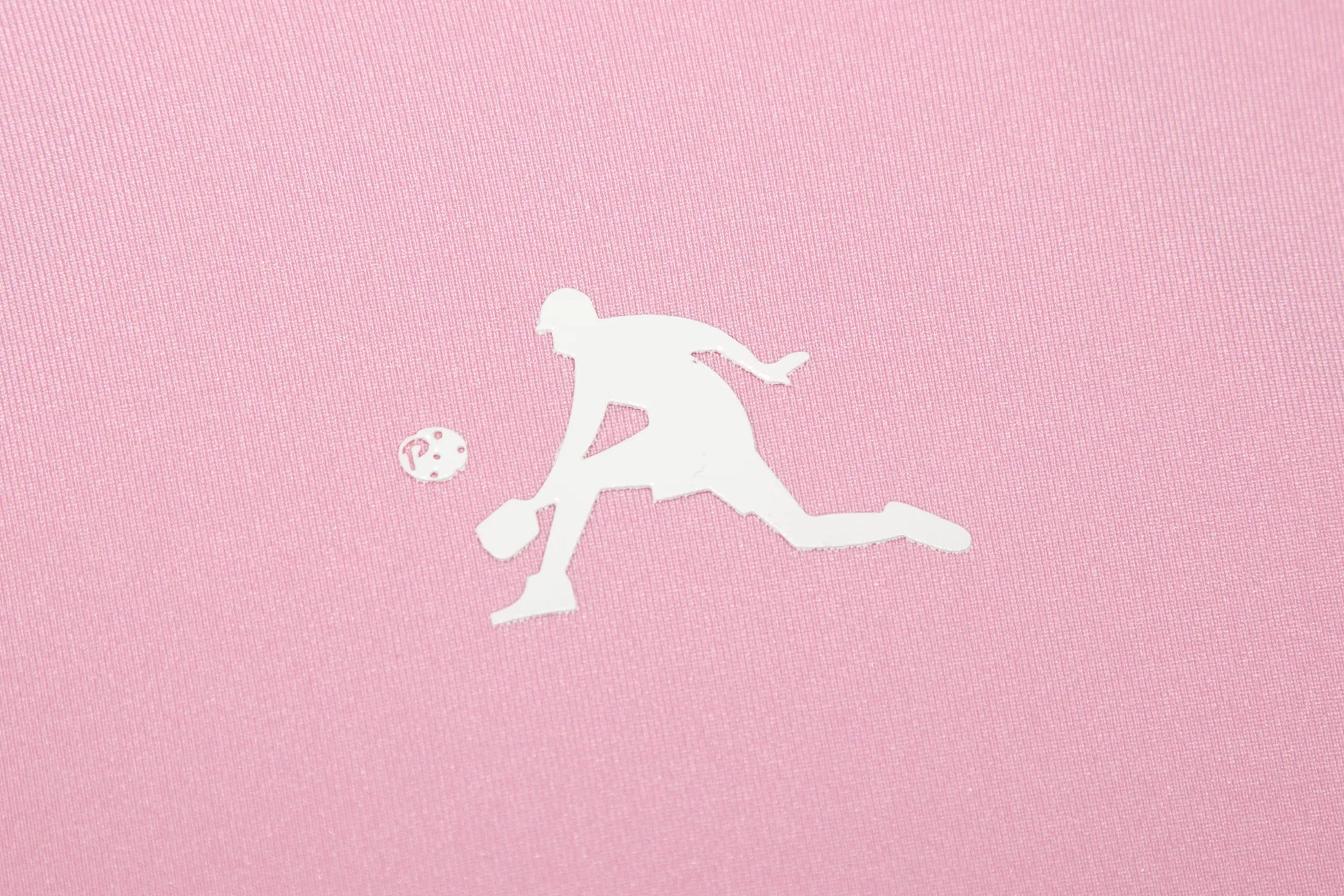 White silhouette of a person playing pickleball on a pink background