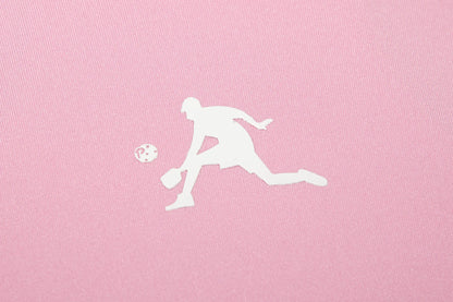 White silhouette of a person playing pickleball on a pink background