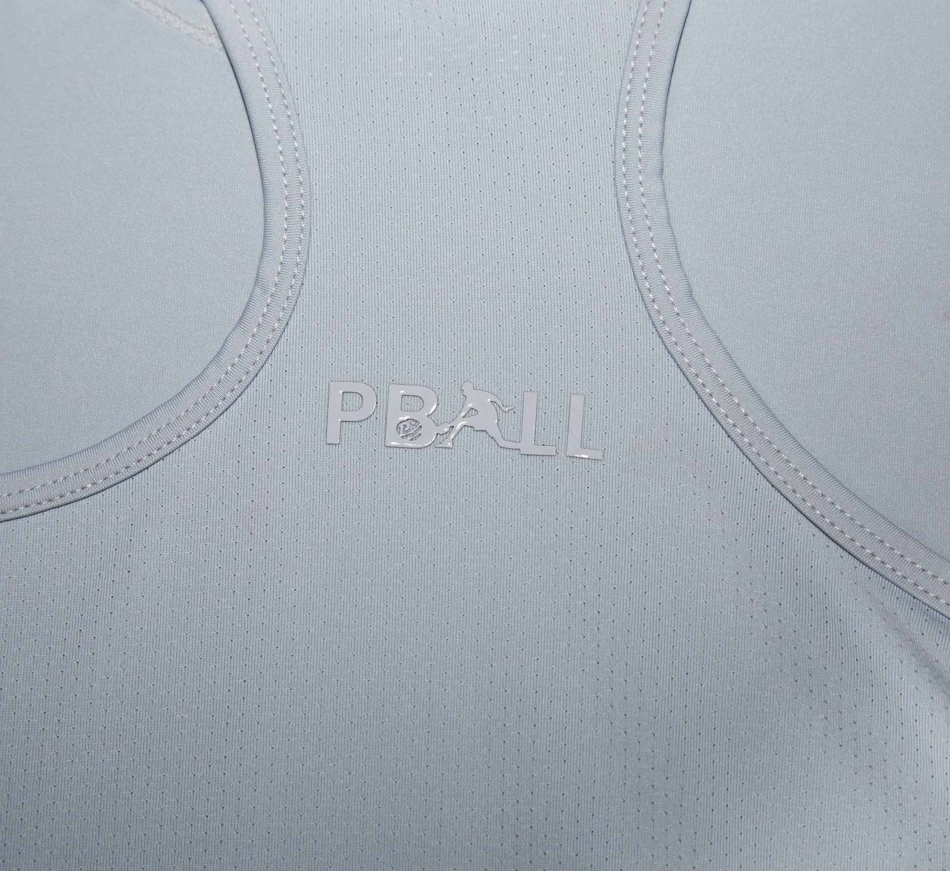 Light Grey fabric with PBALL logo on a close-up of a garment Gris