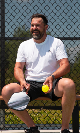 PBALL ambassadors walking on a pickleball court