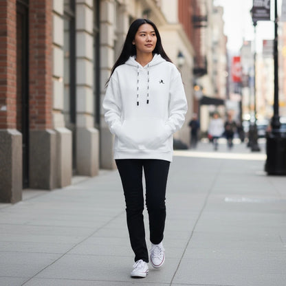 Person wearing a white hoodie with a logo on a city street