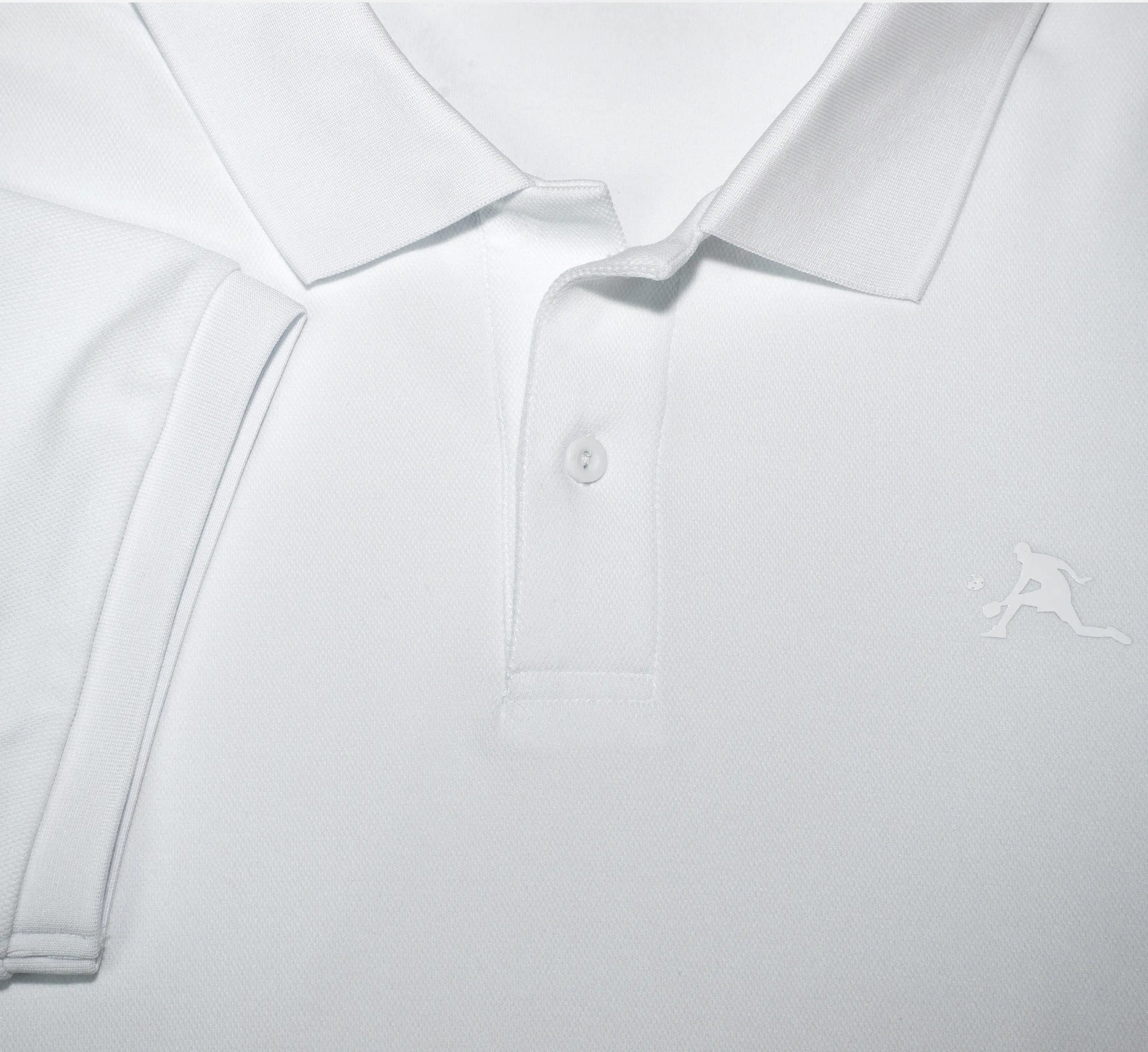 Close-up of a White polo shirt with a small PBALL logo on a light gray background Blanc