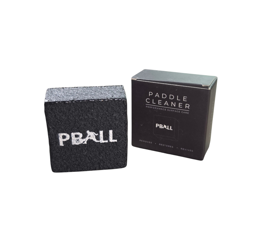 A black textured PBALLpaddle cleaner block next to its black retail box on a plain white background.