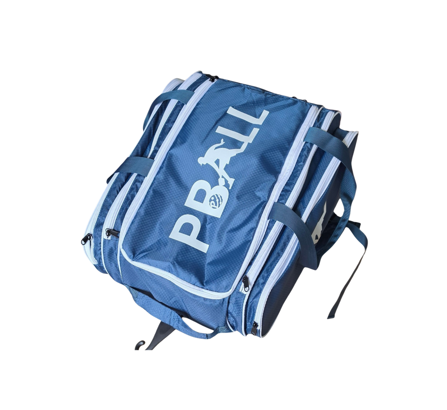 A blue multi-pocket pickleball bag with white piping and a large white 'PBALL' logo printed on the front, shown against a plain white background.