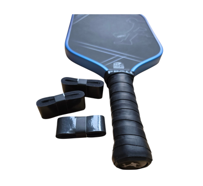 A PBALL pickleball paddle with a black and blue face, black wrapped handle grip, and three black overgrows, shown on a plain white background.