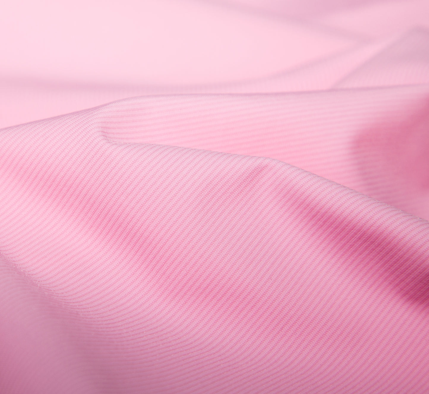 Close-up of pink fabric with a subtle texture