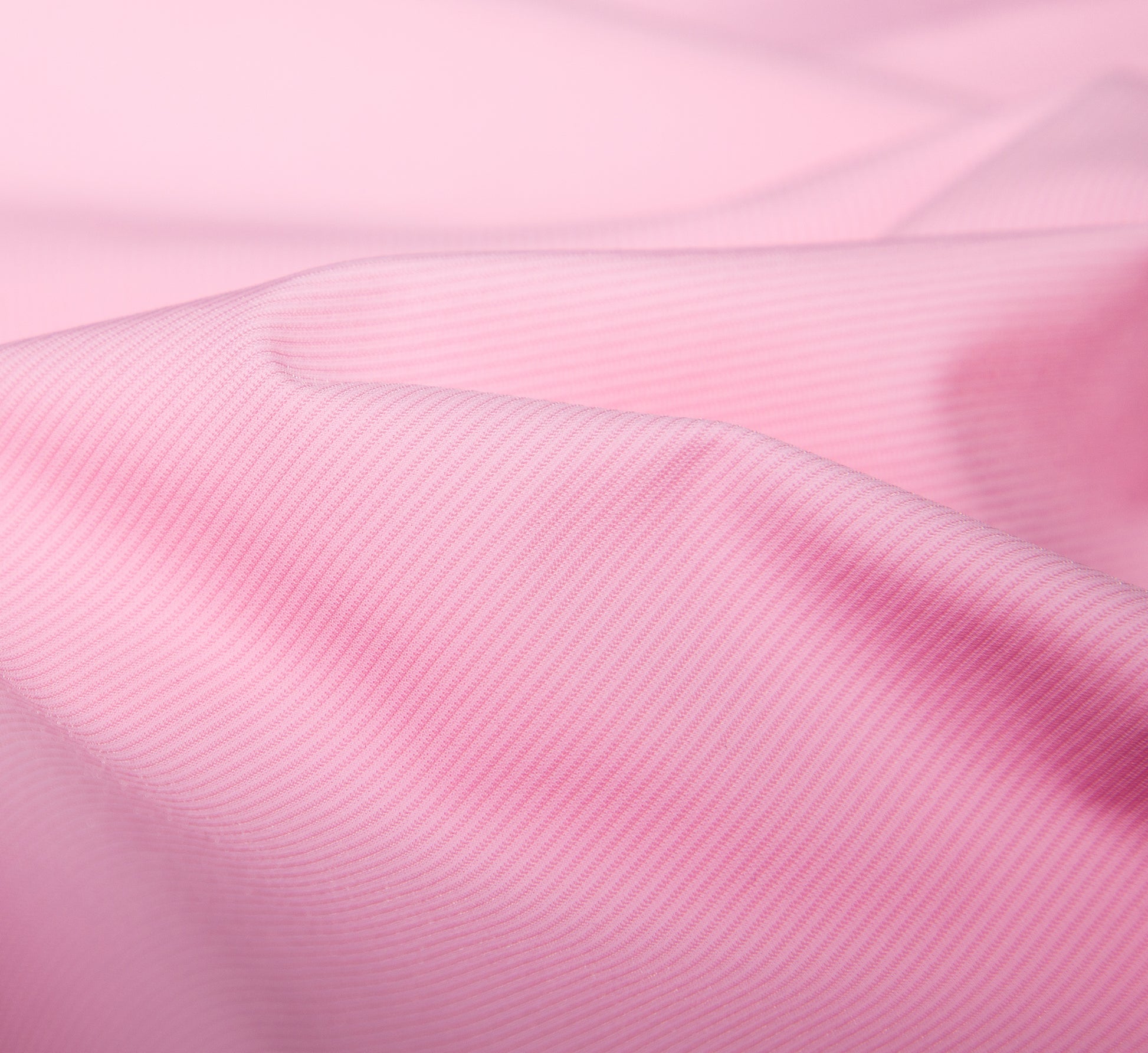 Close-up of pink fabric with a subtle texture